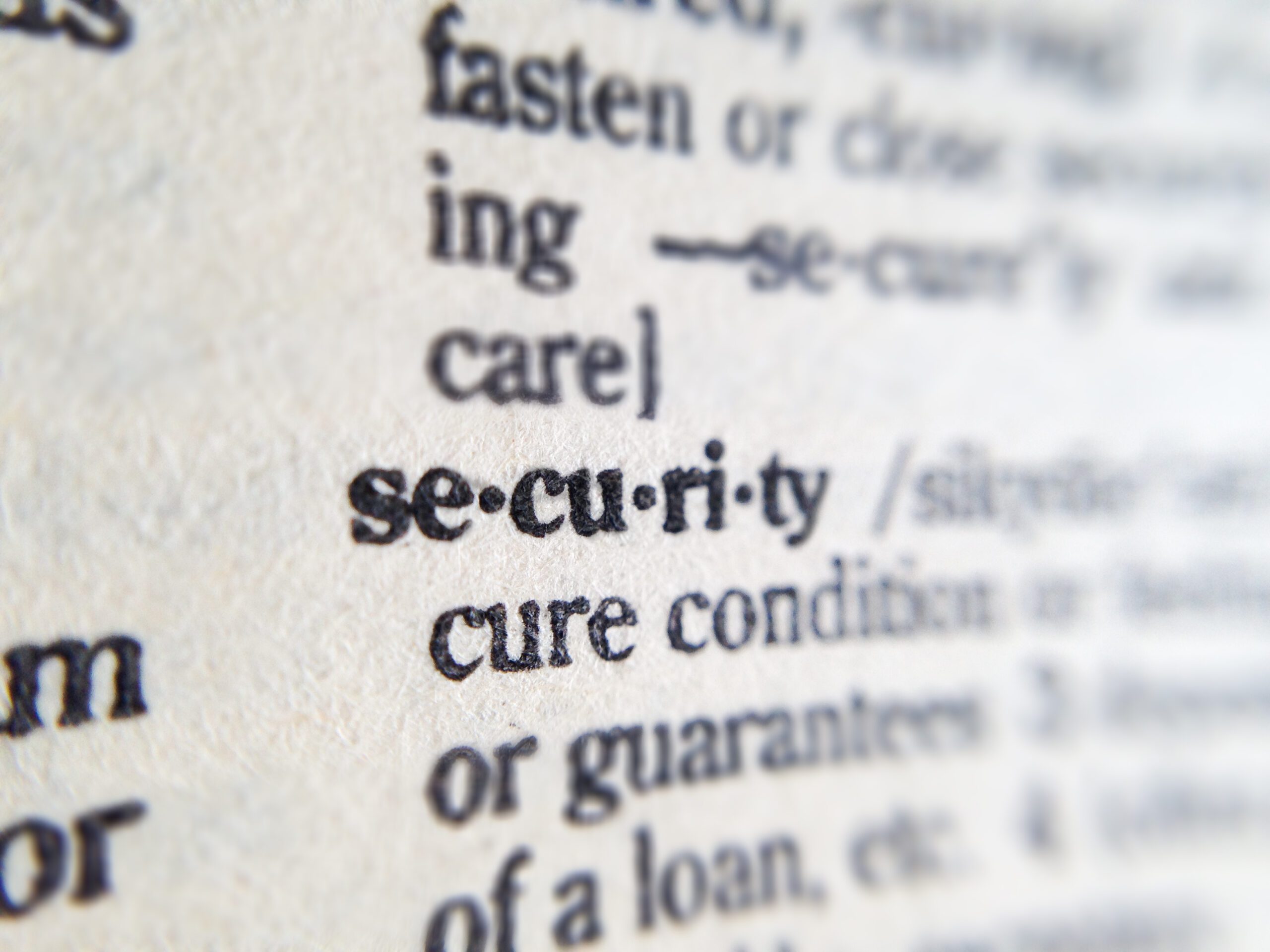 Image of a dictionary page focusing on the term security. This post is about DMCA.